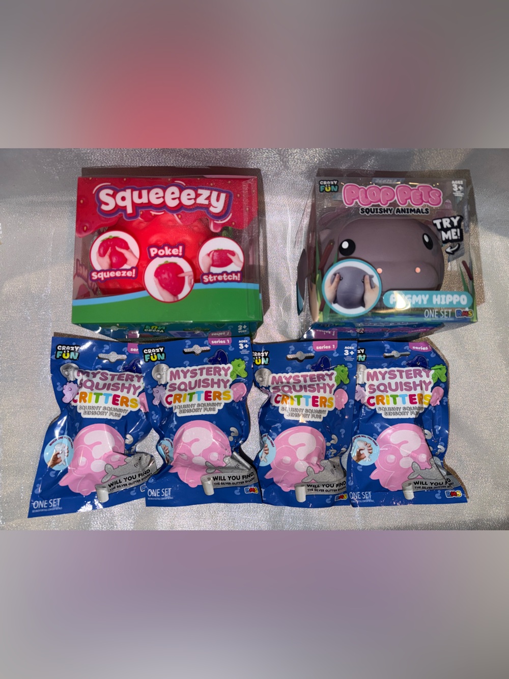 Squeeezy Strawberry, Plop Pets Pygmy Hippo & Four Mystery Squishy Critters Bags